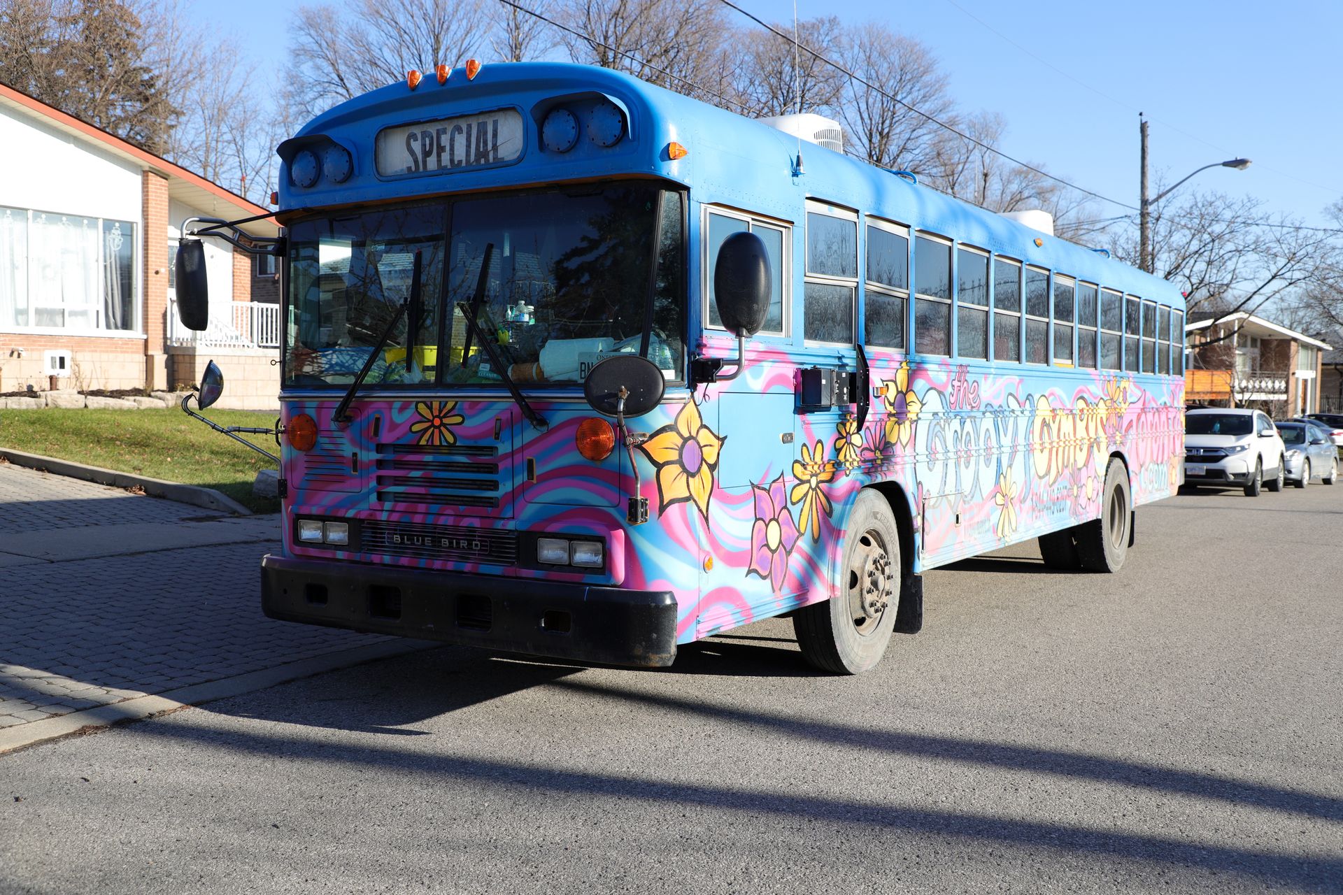 The bus at a community festival, queue of kids alongside